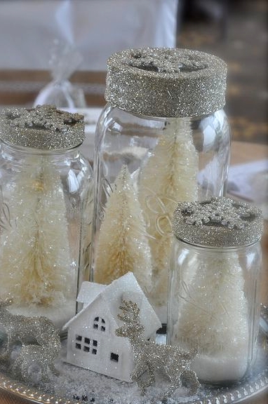 a silver tray with glitter animal figurines, a little house, jars with white glitter bottle brush Christmas trees