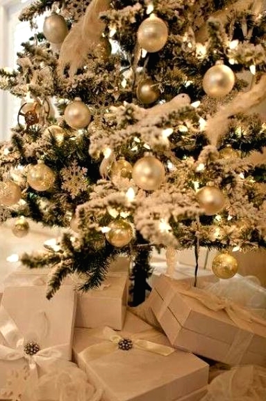 a refined Christmas tree with lights, pearly and gold ornaments, and fluffy garlands is amazing for a winter wonderland space
