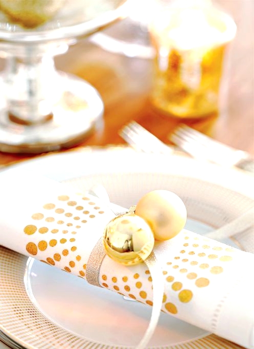a white and gold polka dot plate, a white and polka dot napkin, gold ornaments are amazing for a chic Christmas place setting