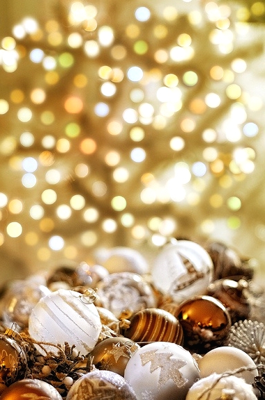shiny and chic gold and white printed Christmas ornaments, evergreens and berries make the space super chic and stylish