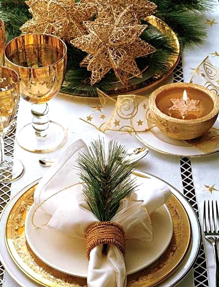 a refined gold and white Christmas tablescape with gold chargers, white porcelain, gold star ribbons, oversized gold wire stars for a centerpiece