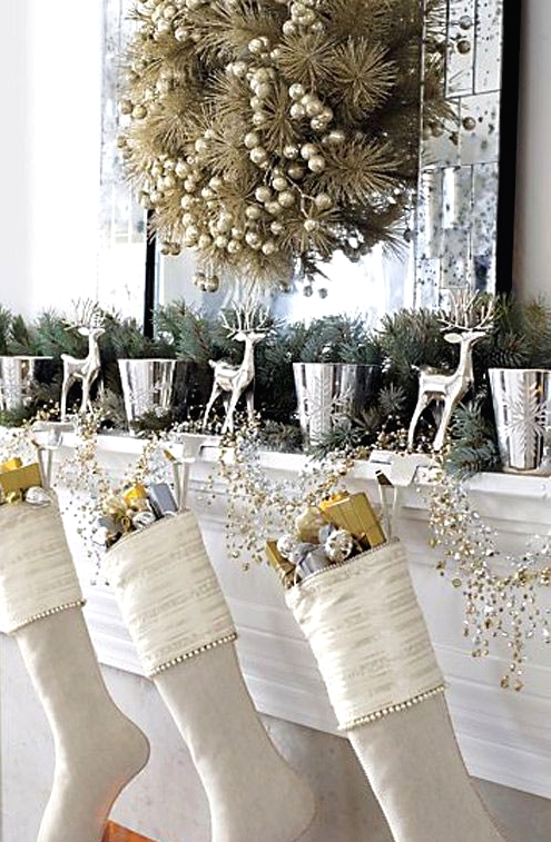 white Christmas stockings with gold and silver ornaments and branches, gift boxes, a gilded evergreen wreath with berries are beautiful and refined