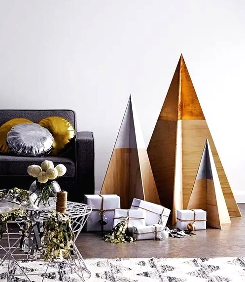 minimalist Christmas trees of plywood with dipped tops are all you need for a laconic interior