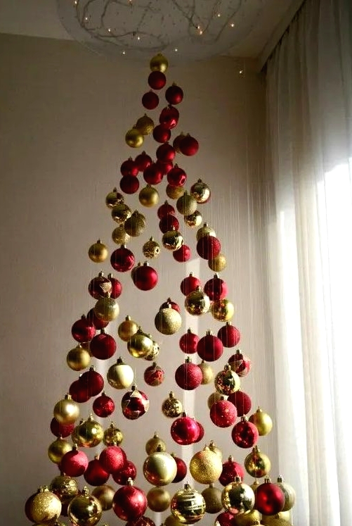a chic Christmas tree of red and gold glitter, shiny and matte ornaments and lights above it is a fresh take on traditional and done in traditional colors