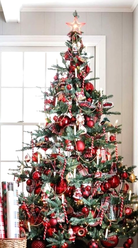 a vintage-inspired Christmas tree with red ornaments, lights and candy candes looks bold and catchy