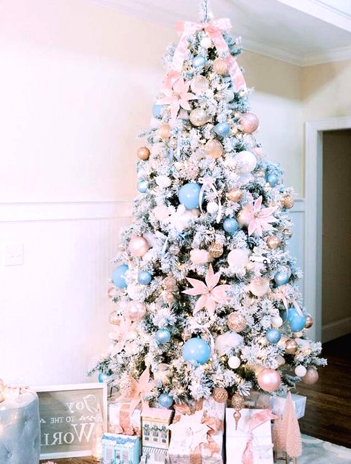 a flocked Christmas tree with blush and light blue ornaments, blush fabric blooms, ribbons and lights is a glam idea to try