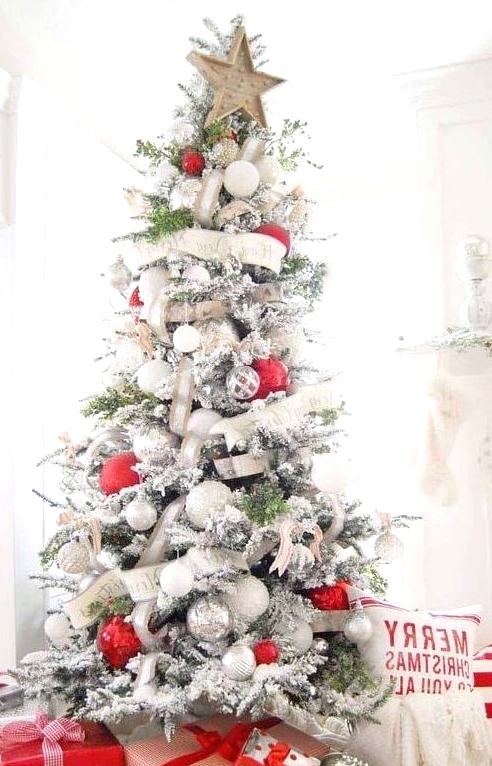 a chic flocked Christmas tree with white and burlap ribbons, white and metallic ornaments and oversized red ones