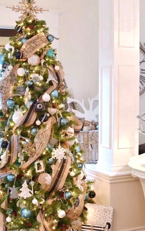 a chic Christmas tree with a vintage flavor, blue, white and black ornaments and striped and music note ribbons