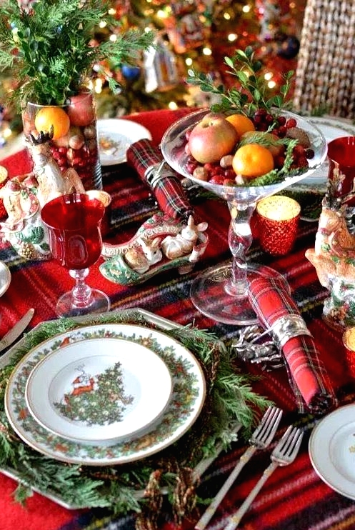 a plaid tablecloth and napkins add a cozy traditional feel to the table, and evergreens make it lively