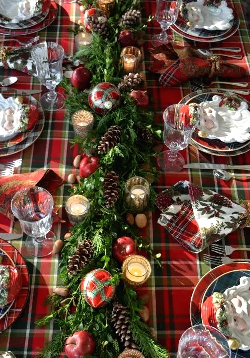 a plaid tablecloth, plaid napkins and plates and even plaid ornaments refreshed with evergreens