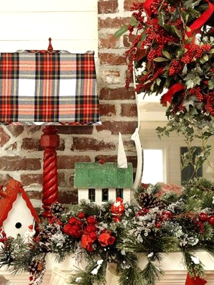 a red lamp with a plaid lampshade adds a cozy holiday feel to the space and makes it look festive