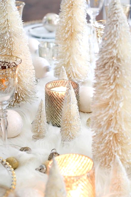 a gorgeous glam winter wonderland Christmas table with faux fur, white and gold ornaments, bottle cleaner trees and gold accents