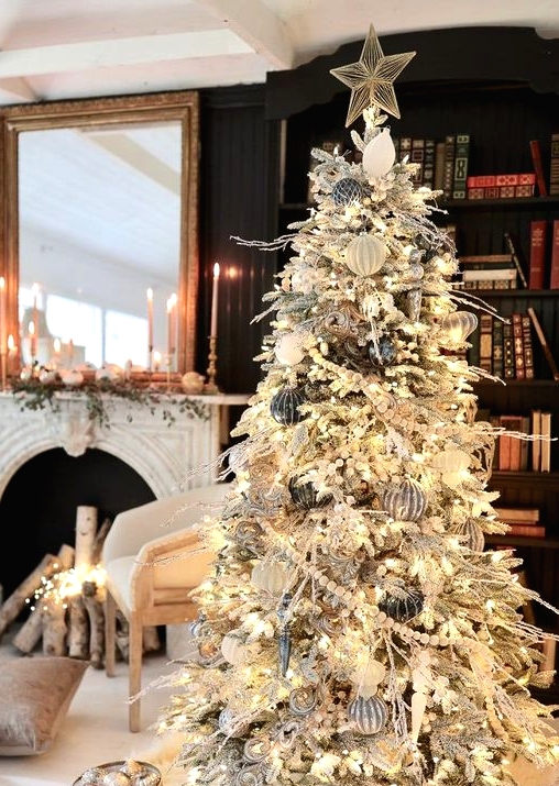 a refined winter wonderland Christmas tree with black, silver and white ornaments, beads, lights and a star tree topper is a gorgeous statement
