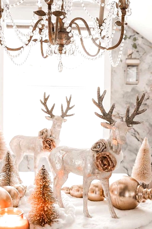 winter wonderland tablescape with candles, metallic ornaments, metallic deer figurines, bottle brush Christmas trees