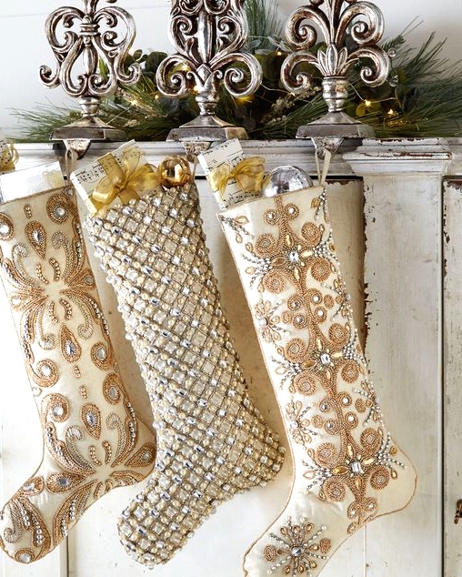 beautiful sophisticated neutral embellished Christmas stockings with ornamnes and gifts are amazing to style your refined space for Christmas