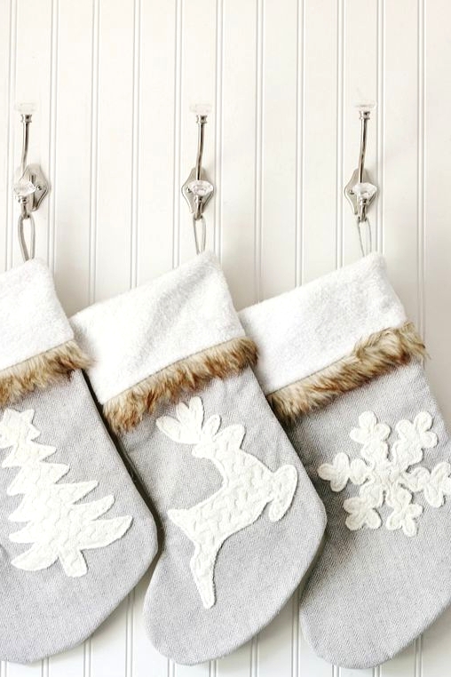 pale blue Christmas stockings with white themed appliques and faux fur are amazing for relaxed holiday spaces