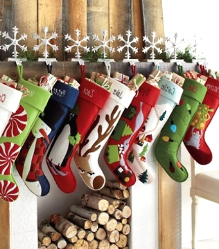 colorful stockings attached to the mantel with snowflakes will make your space more fun, bright and Christmassy