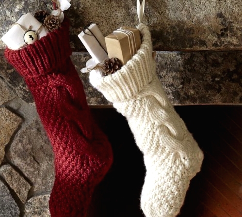 simple red and white knit stockings with gift boxes, pinecones and bells will make your space naturally festive and very cozy