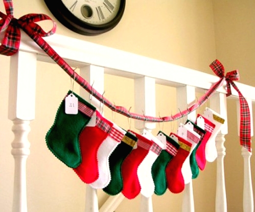 a bright holiday garland of colorful mini stockings on a red plaid ribbon is a cool idea for styling your mantel or railing, and you can DIY it