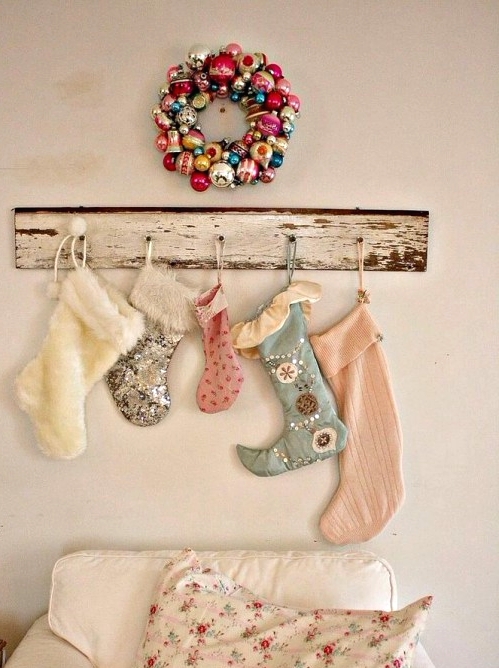 a whitewashed shabby chic holder with various mismatching pastel and white stockings with sequins and embellishments is a great and relaxed Christmas decoration