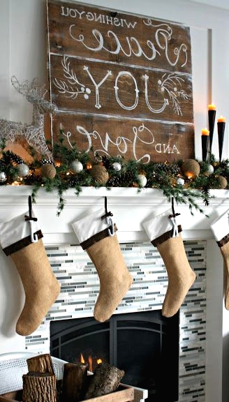a beautifully styled Christmas mantel with evergreens, gold and silver ornaments, lights and burlap stockings for a lively holiday space and much coziness
