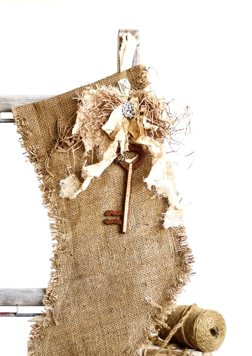 a burlap stocking with some hay, a vintage key and embellishments is a pretty rustic decor idea for a rustic Christmas space