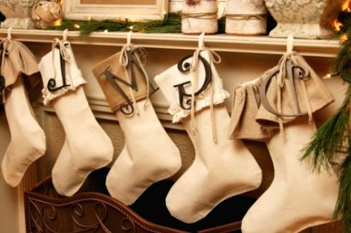 tan and white fabric stockings with monograms are amazing to style a neutral space for Christmas without interfering into the color scheme