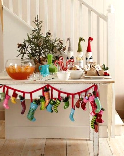 a drink station with a colorful mini stocking garland accenting it is a lovely idea for a modern Christmas space with plenty of color