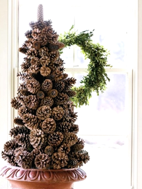a pinecone Christmas tree in a bowl is a chic and cool idea for a rustic or woodland holiday space