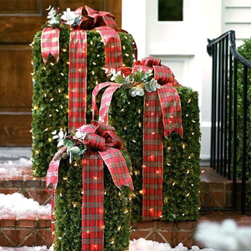 greenery and lights gift boxes with red plaid ribbons and evergreens on top are cool Christmas decor