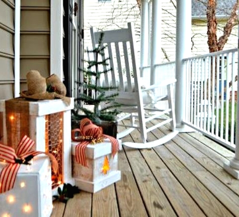 gift boxes with lights and bows on top are amazing to give a cozy festive feel to your porch