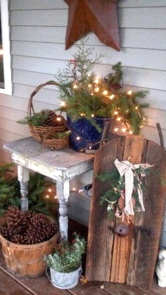 outdoor Christmas decor with evergreens, lights and pinecones is a lovely idea for a rustic space, and light will give a festive feel to the space