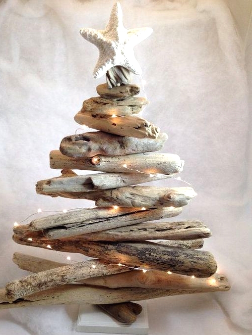 a coastal Christmas tree of driftwood, with lights and with a starfish on top is a cool idea for a beach Christmas space