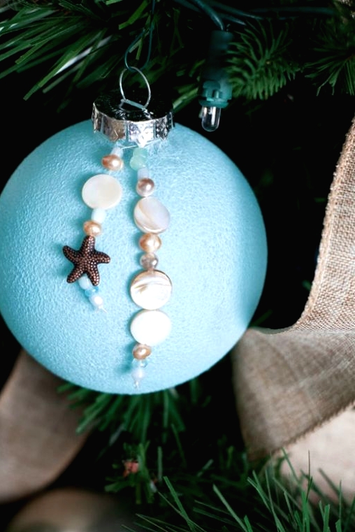 an oversized blue Christmas ornament with pearls, a starfish and beads is a lovely idea for a beach Christmas space