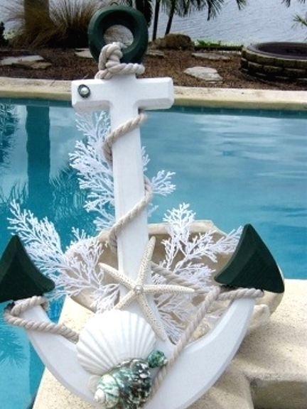 a white anchor with rope, seashells, starfish and corals is a lovely decoration to place outdoors for Christmas