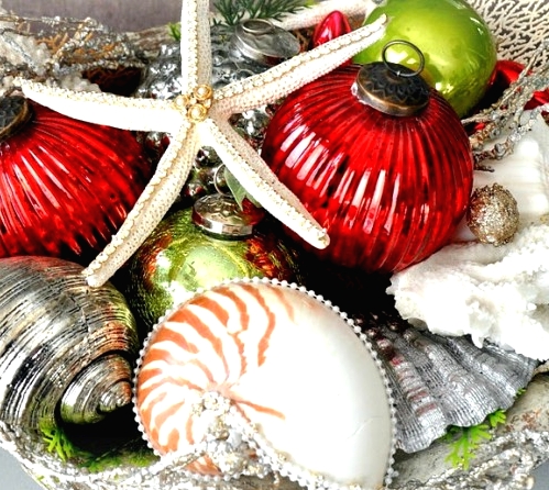 a bold beach Christmas centerpiece of bright vintage Christmas ornaments, starfish and seashells is a pretty idea you can easily realize
