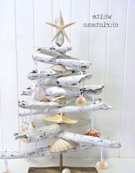 a whitewashed driftwood Christmas tree decorated with seashells and starfish is a pretty Christmas decoration