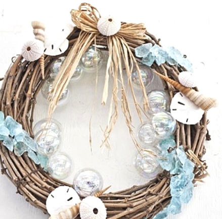 a beach Christmas wreath of vine with clear glass baubles, seashells, sea urchins and light blue sea glass is amazing