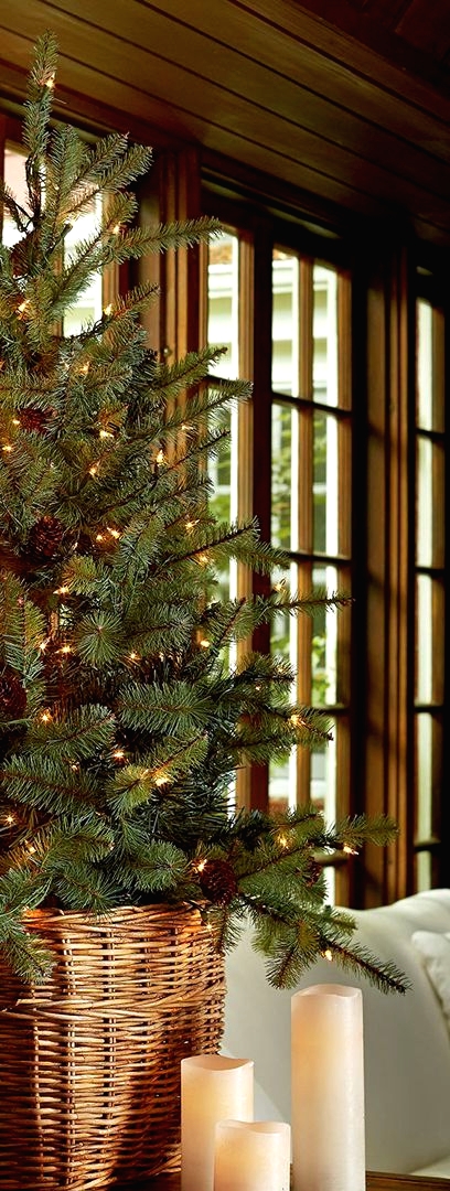 a modern Christmas tree with pinecones and lights placed into a basket is a lovely idea for a modern home
