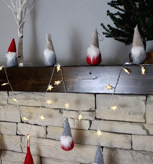 pretty Christmas decor - red and grey gnomes n hats, a star-shaped light garland are all you need for a cool Christmas mantel
