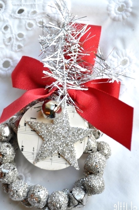 a silver glitter bell Christmas ornaments with a matching star, with a large red bow and bottle cleaner is a cool decor piece for Christmas