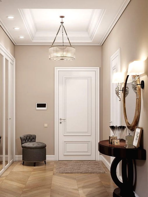a sophisticated greige entryway with white doors and a built-in storage unit with mirror doors, a grey stool and a refined dark console table plus cool lamps