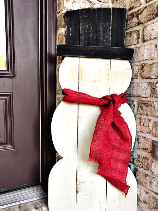 a white plywood snowman with a top hat and a red burlap scarf is a cool and bold idea for styling your outdoor space, you can DIY it