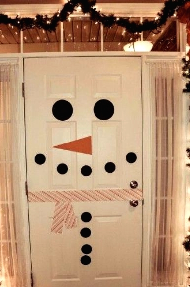 a front door styled as a snowman created with colorful washi tape is a great idea to add a bit of fun to your space