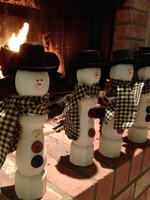 white banisters turned into snowmen, with hats, scarves and buttons are a great Christmas decor idea to rock