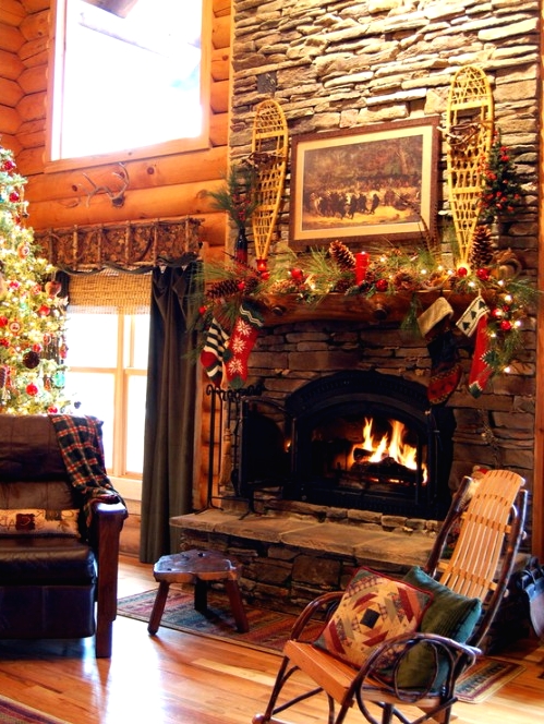a cozy cabin Christmas mantel with a lush evergreen garland, pinecones, red ornaments and vintage ski is a creative idea