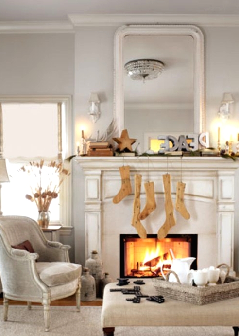 a simple modern Christmas mantel with PEACE letters, wooden stockings, a wooden star and a stack of books