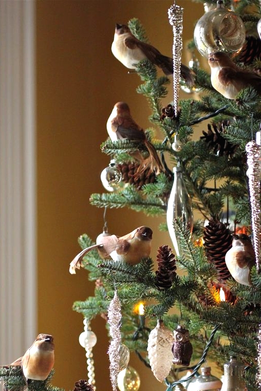 forest Christmas tree decor with bird figurines, pinecones, white, sivler and gold ornaments and icicles and lights is cool