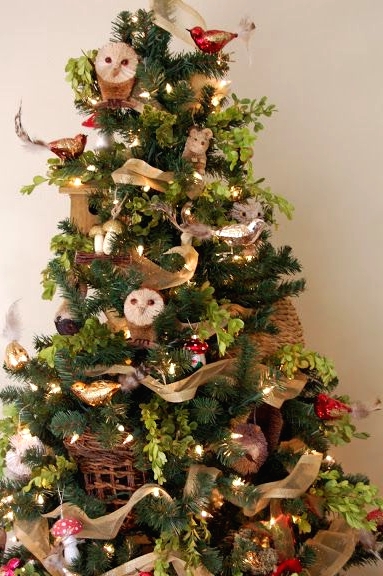 a fun woodland Christmas tree with owls, bird ornaments, lights, mushrooms, acorns, garlands and green branches is a very cool and unusual idea