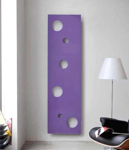 a modern space with an elegant black leather chair and a playful lilac pola dot radiator on the wall for a touch of color and fun
